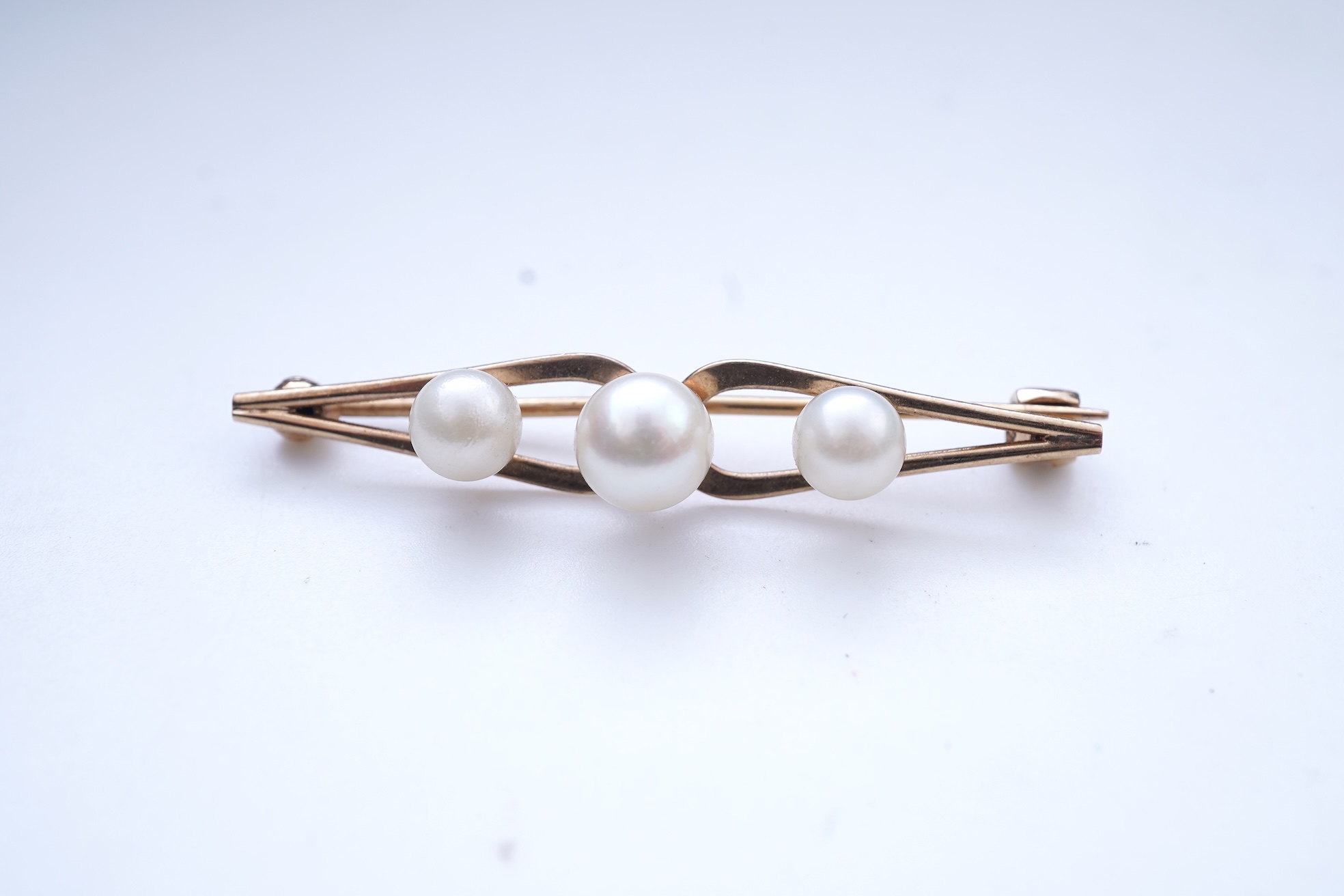 A group of cultured pearl jewels, comprising: two pairs of cultured pearl drop earrings, longest 3cm, mounted in gold; and two cultured pearl brooches mounted in 9ct gold, longest 4.1cm, British hallmarks, combined gross